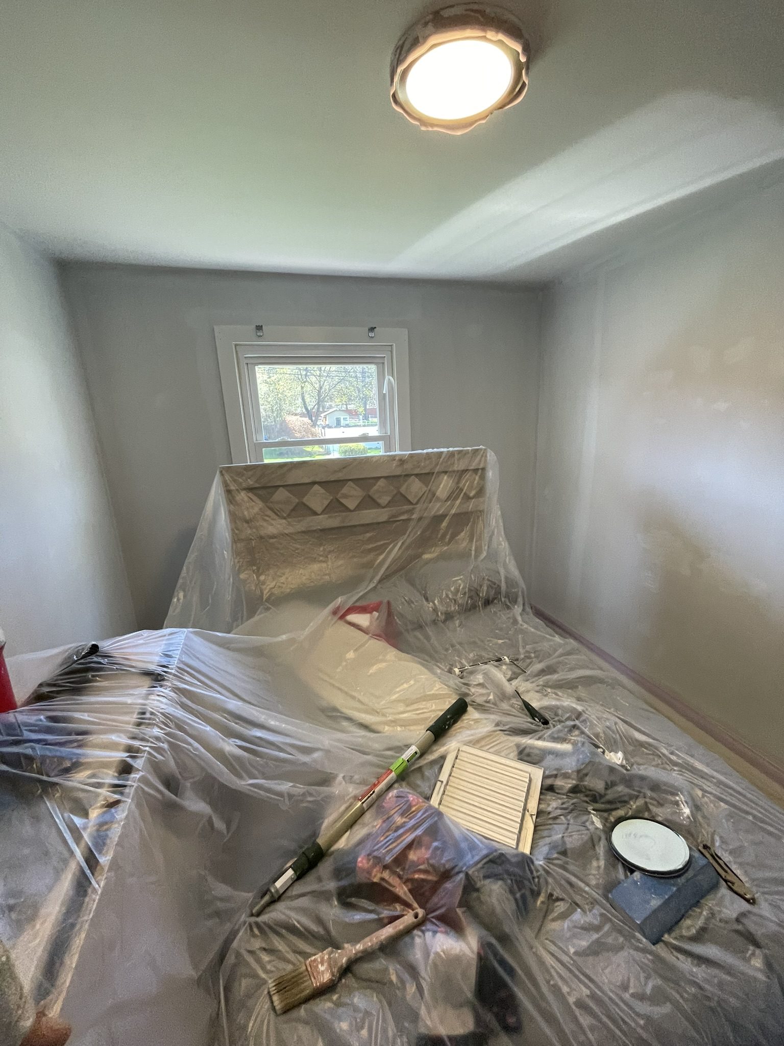 Before: bedroom with old pink walls, masking tape applied — ready for interior painting Westchester NY