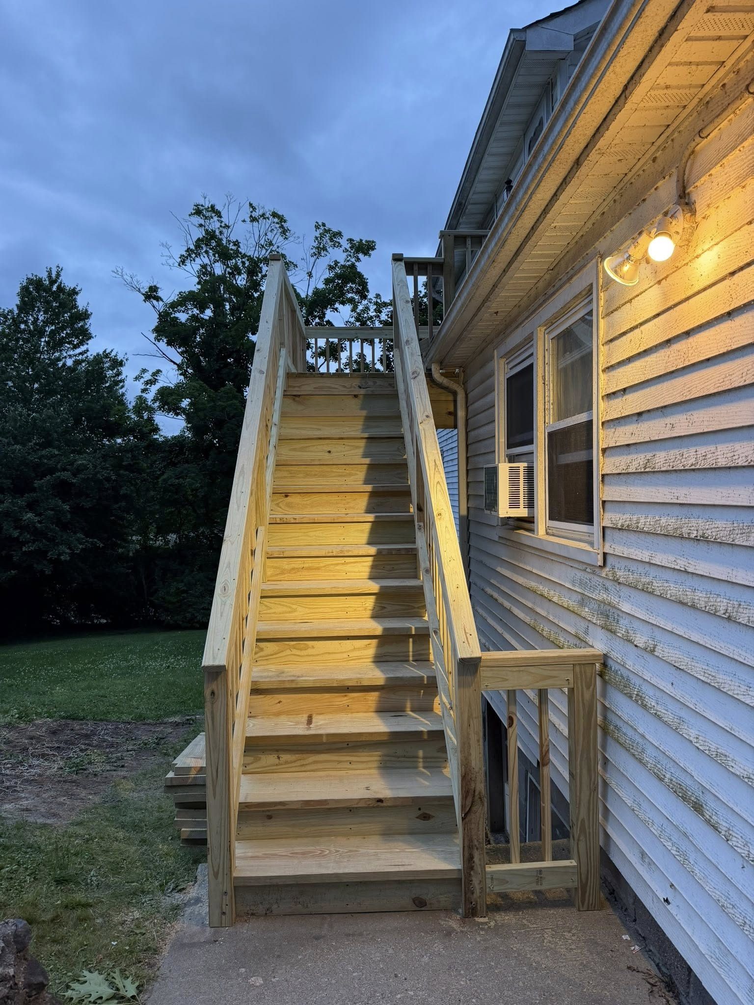 After: new pressure treated wood deck staircase completed at dusk — Westchester NY