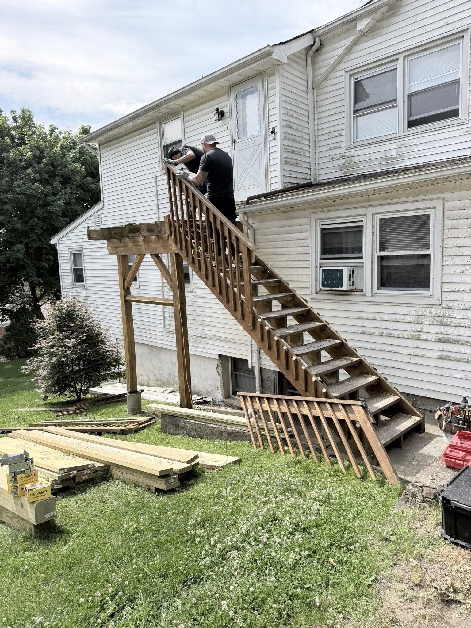 Before: aging deck stairs worn railing